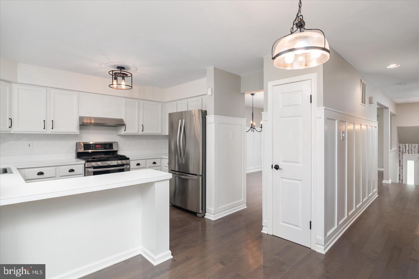 2441 Winding Ridge Road Odenton, MD 21113 - Photo 3 of 20 a kitchen with stainless steel appliances a refrigerator sink and cabinets
