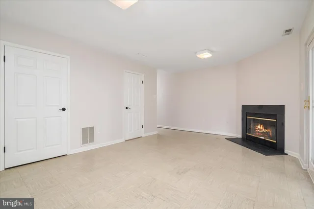 a view of an empty room with a fireplace