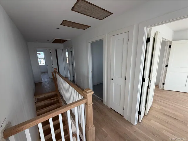 a view of an entryway with wooden floor and stairs