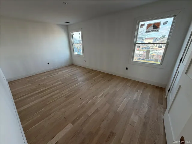 a bathroom with double vanity and a window