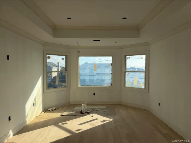 a view of a big room with wooden floor and windows
