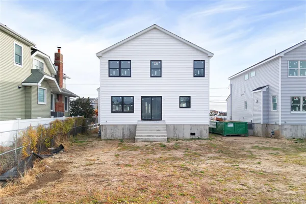 a front view of a house with a garden and yard
