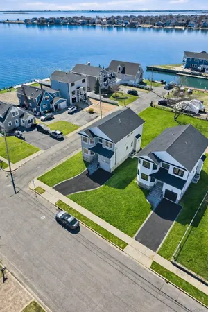 an aerial view of residential houses with city view
