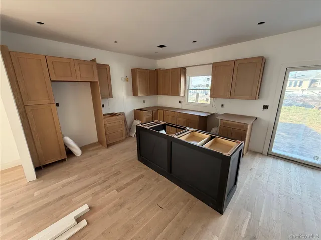 a kitchen with granite countertop a sink and a refrigerator