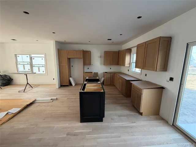 a kitchen with stainless steel appliances granite countertop a sink stove and wooden cabinets