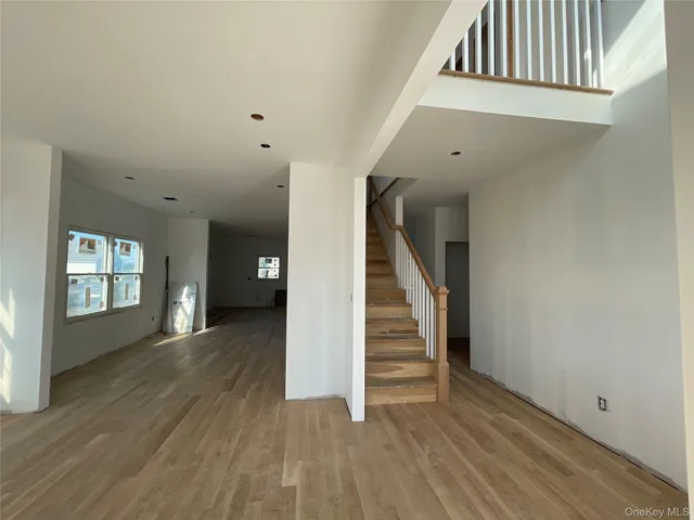 wooden floor in a hall with an entryway and a livingroom