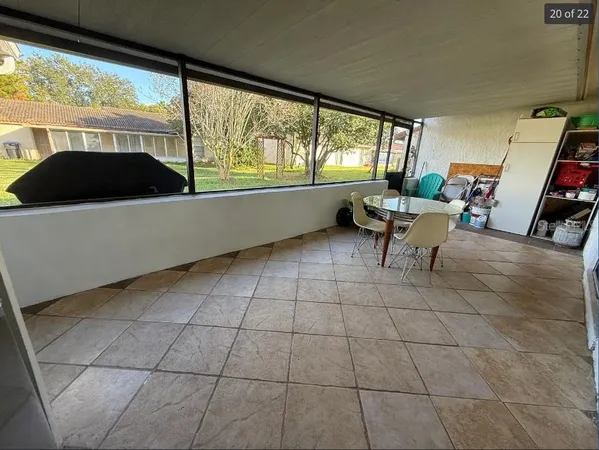 a living room with a large window and a table