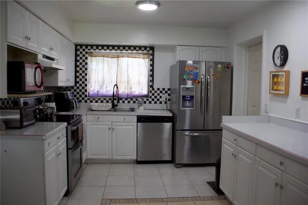 a kitchen with a refrigerator and a sink