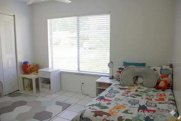 a bedroom with a bed and a window