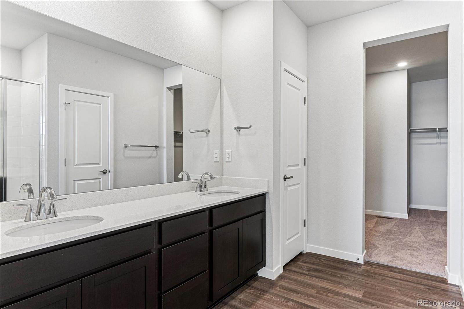 4224 Gozzer Ranch Drive Elizabeth, CO 80107 - Photo 15 of 21 a bathroom with a double vanity sink and a mirror