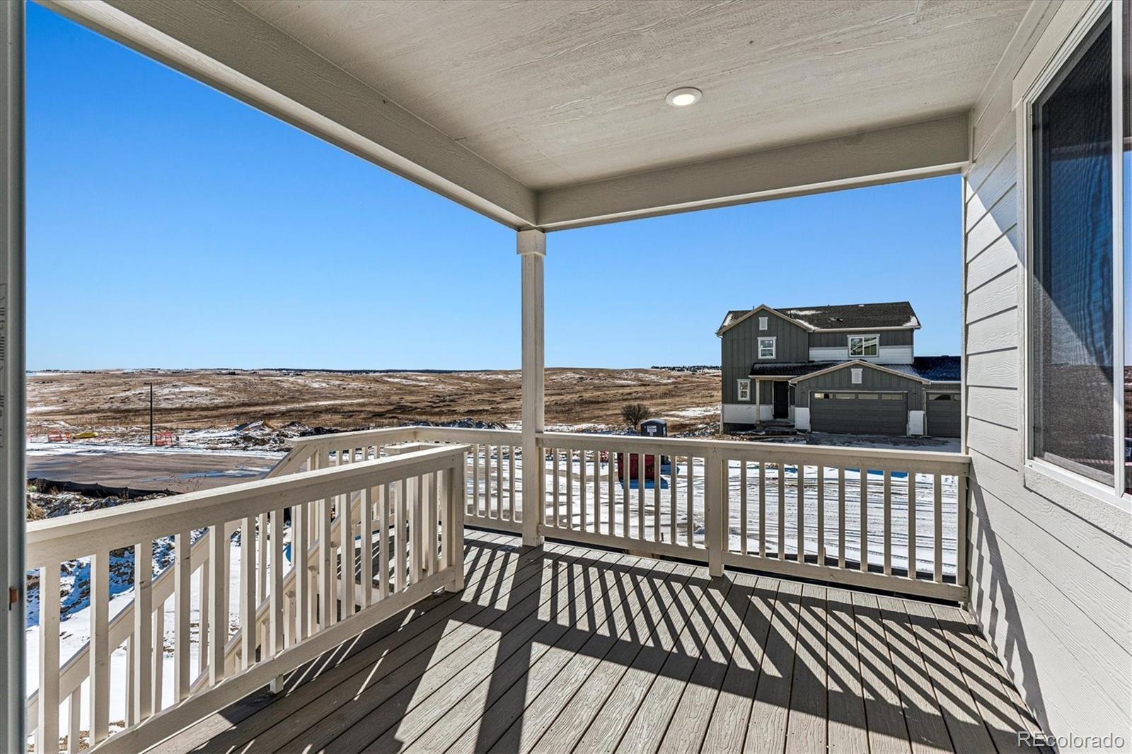4224 Gozzer Ranch Drive Elizabeth, CO 80107 - Photo 18 of 21 a view of a balcony with wooden floor