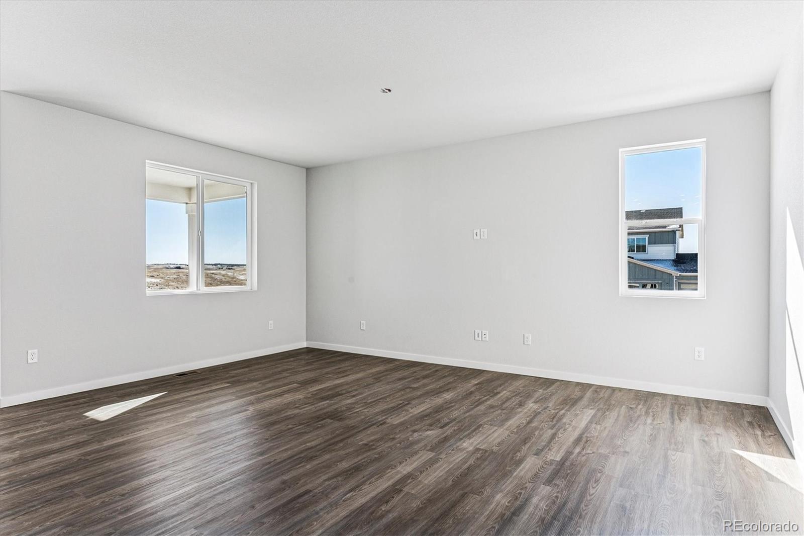 4224 Gozzer Ranch Drive Elizabeth, CO 80107 - Photo 7 of 21 a view of an empty room with wooden floor and a window