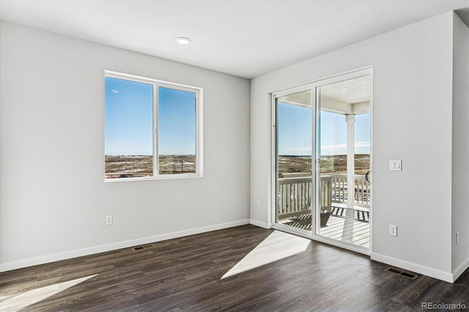 4224 Gozzer Ranch Drive Elizabeth, CO 80107 - Photo 8 of 21 an empty room with wooden floor and windows