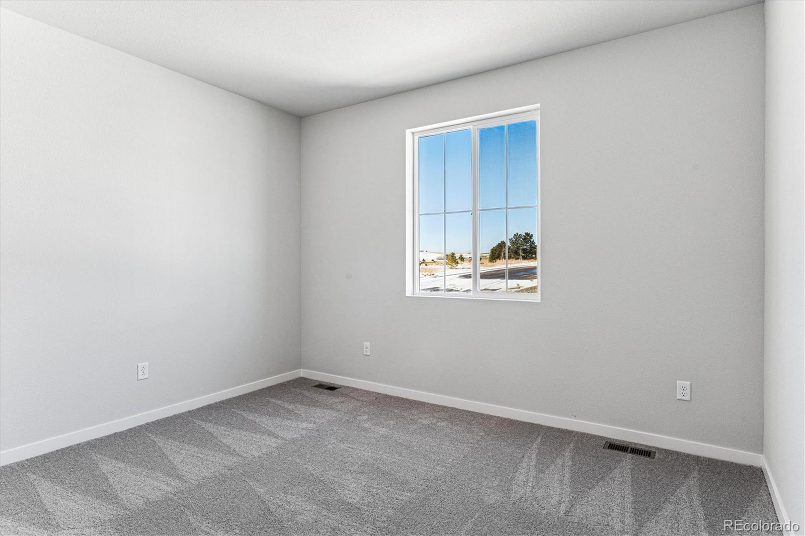 4224 Gozzer Ranch Drive Elizabeth, CO 80107 - Photo 10 of 21 an empty room with windows