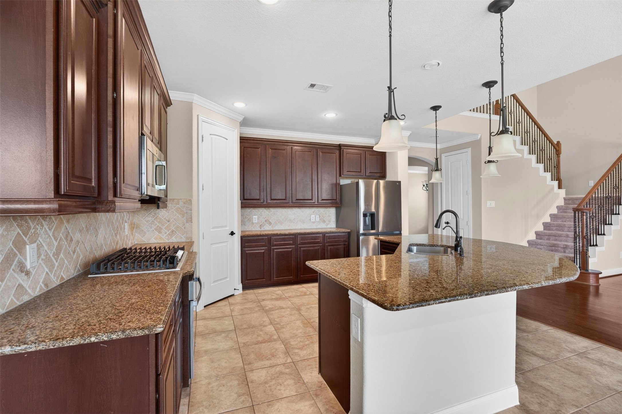18202 Wedgewood Bluff Court Spring, TX 77379 - Photo 23 of 50 Kitchen appliance view featuring stainless microwave, oven, and surrounding cabinetry.