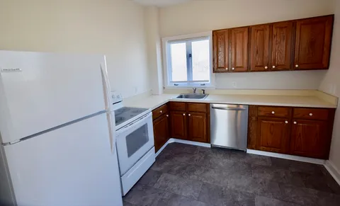 a kitchen with a sink a stove and cabinets