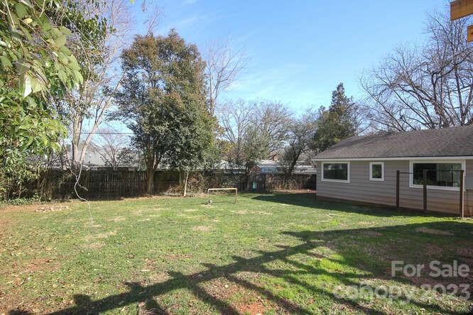 801 Fairbanks Road Charlotte, NC 28210 - Photo 30 of 39 a backyard of a house with yard and trampoline