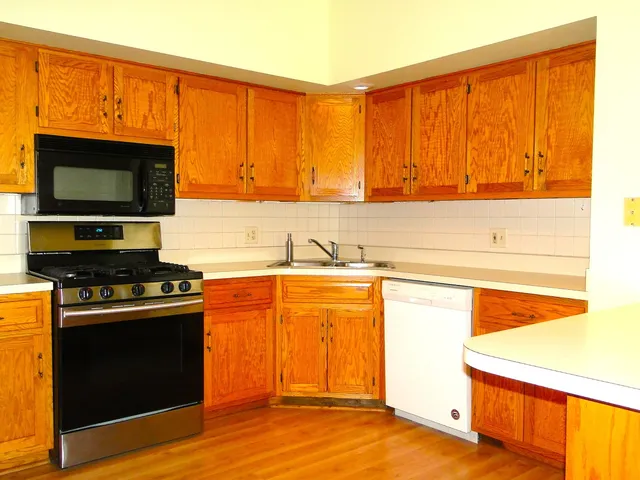 a view of a kitchen with wooden floor and a sink