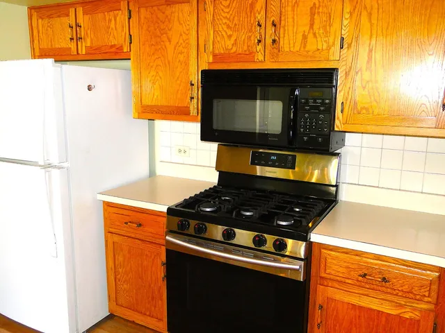 a kitchen with stainless steel appliances granite countertop a stove and a microwave