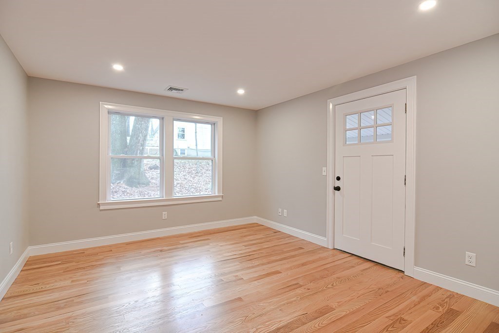 108 Olive Street Ashland, MA 01721 - Photo 12 of 34 a view of an empty room with wooden floor and a window