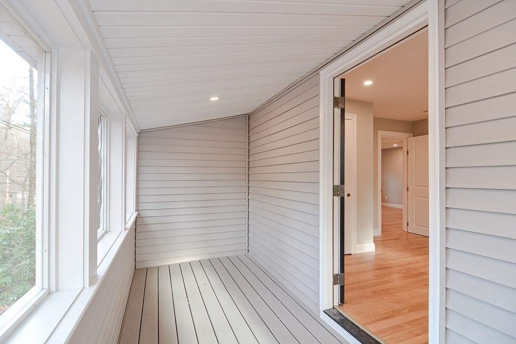 108 Olive Street Ashland, MA 01721 - Photo 15 of 34 a view of a hallway with wooden floor and staircase