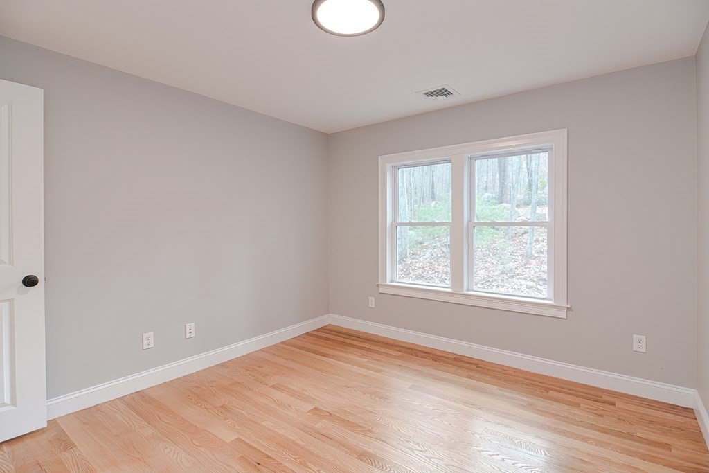 108 Olive Street Ashland, MA 01721 - Photo 17 of 34 a view of an empty room with wooden floor and a window