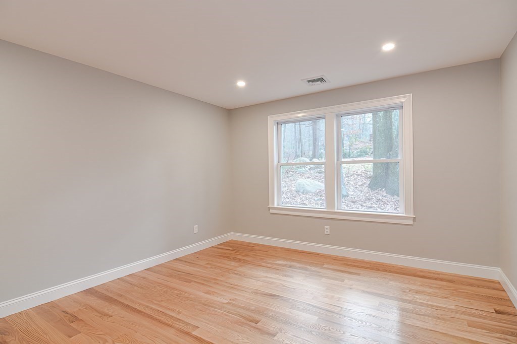 108 Olive Street Ashland, MA 01721 - Photo 22 of 34 an empty room with wooden floor and windows
