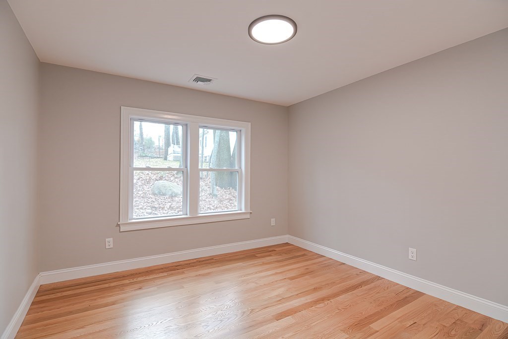 108 Olive Street Ashland, MA 01721 - Photo 23 of 34 an empty room with wooden floor and windows