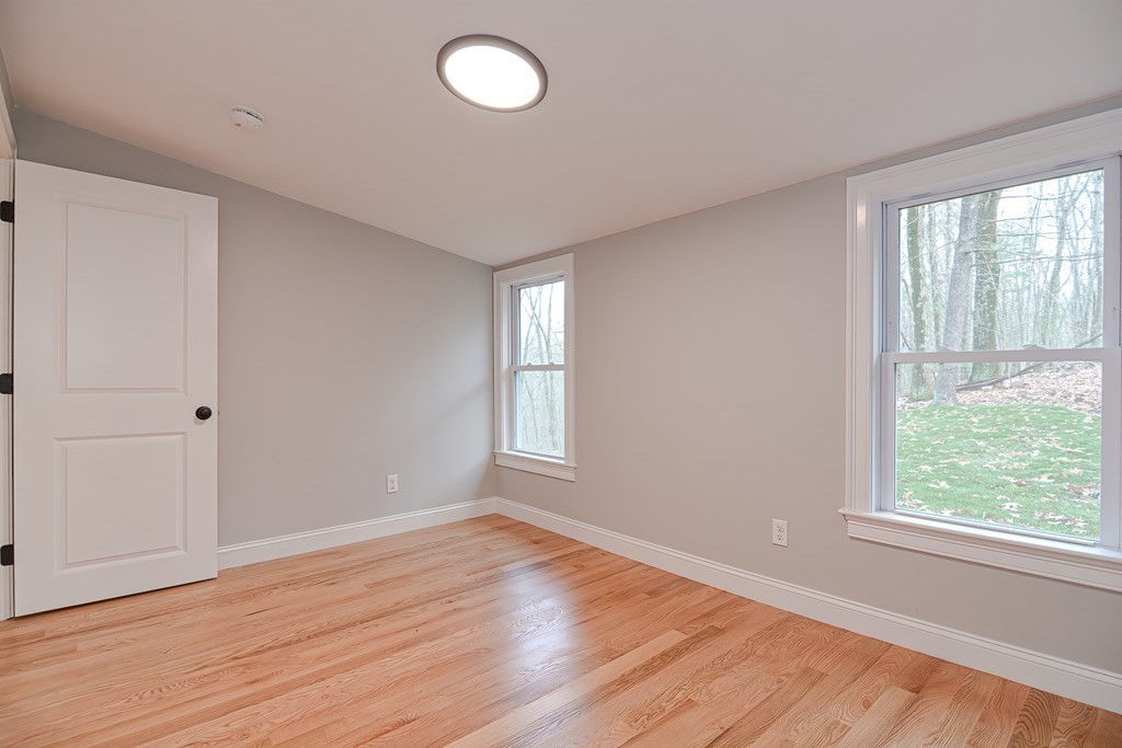 108 Olive Street Ashland, MA 01721 - Photo 24 of 34 a view of an empty room with wooden floor and a window