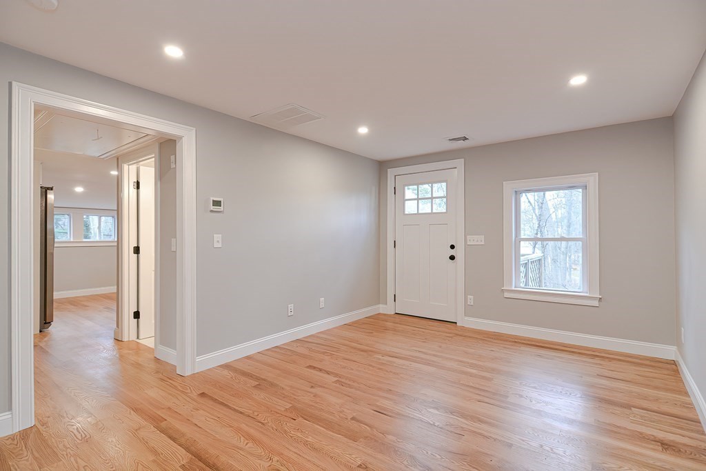 108 Olive Street Ashland, MA 01721 - Photo 6 of 34 a view of an empty room with wooden floor and a window