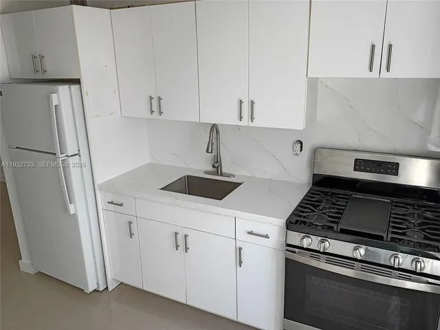 a view of cabinets and refrigerator