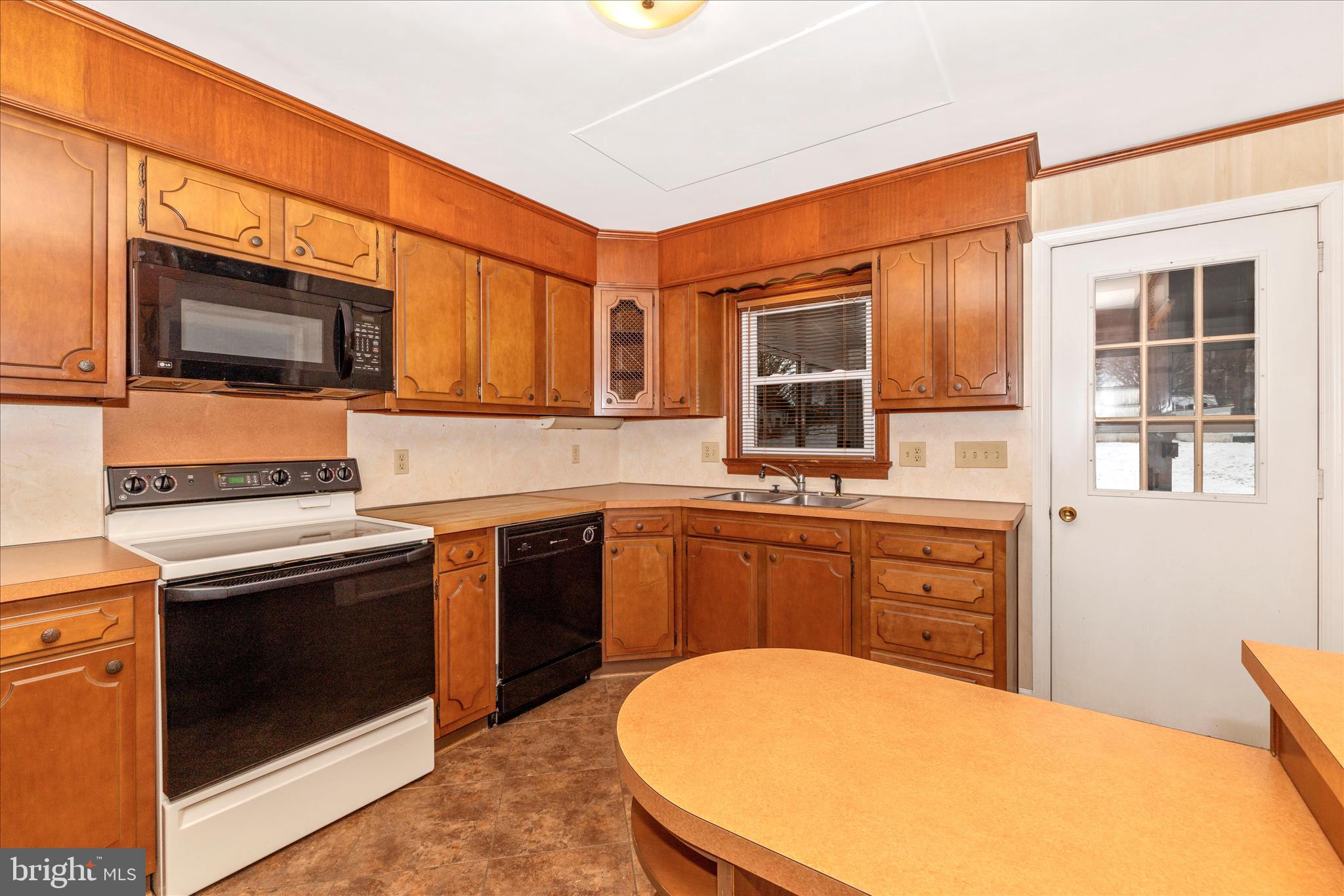 215 Broad Street Middletown, MD 21769 - Photo 15 of 56 a kitchen with stainless steel appliances a stove microwave and sink
