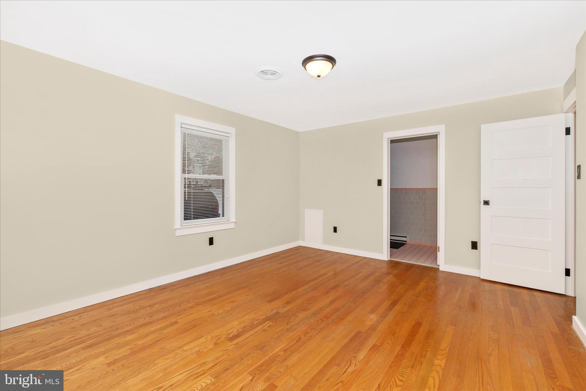 215 Broad Street Middletown, MD 21769 - Photo 23 of 56 a view of an empty room with wooden floor and a window