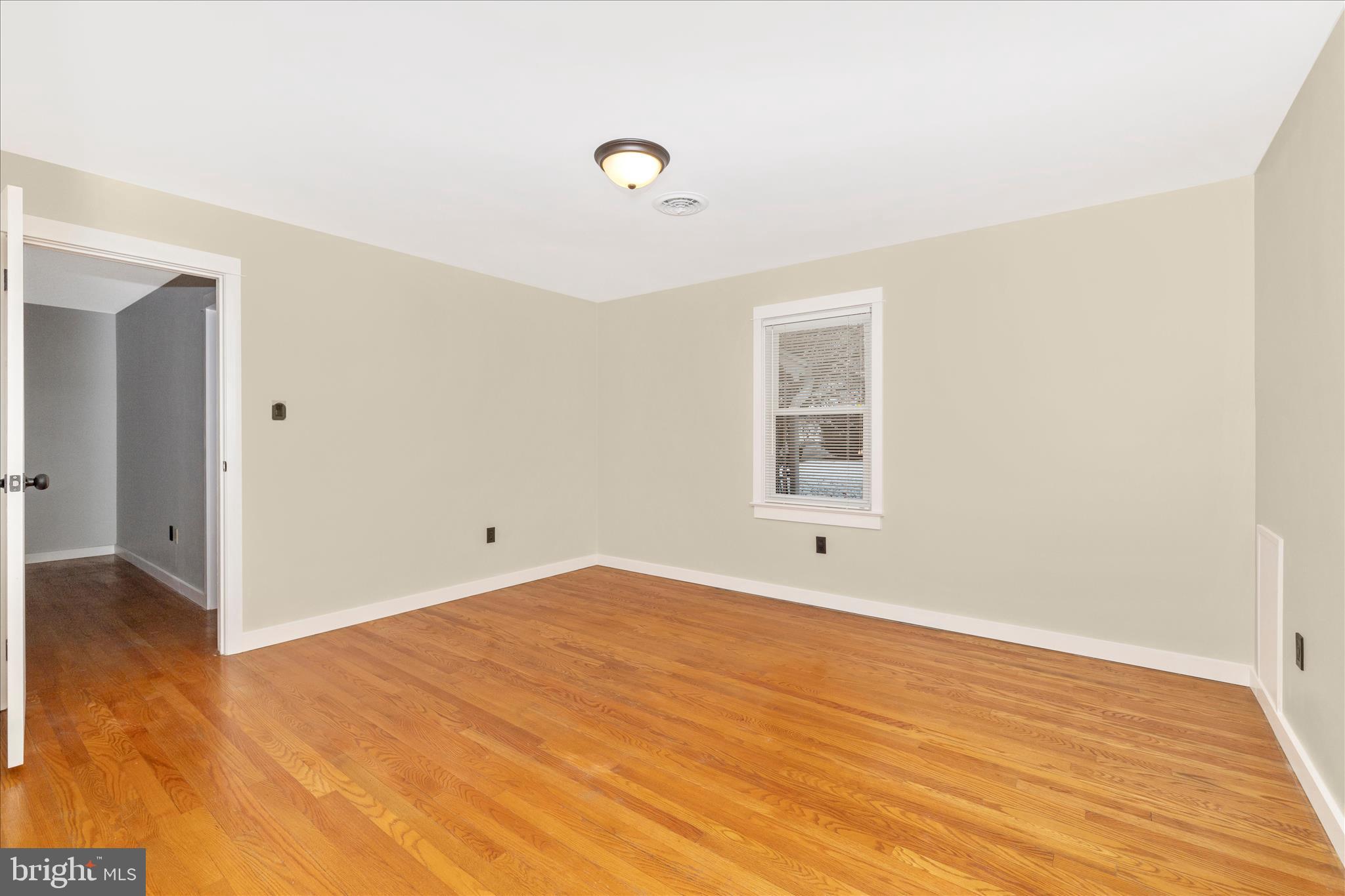 215 Broad Street Middletown, MD 21769 - Photo 25 of 56 a view of an empty room with wooden floor and a window