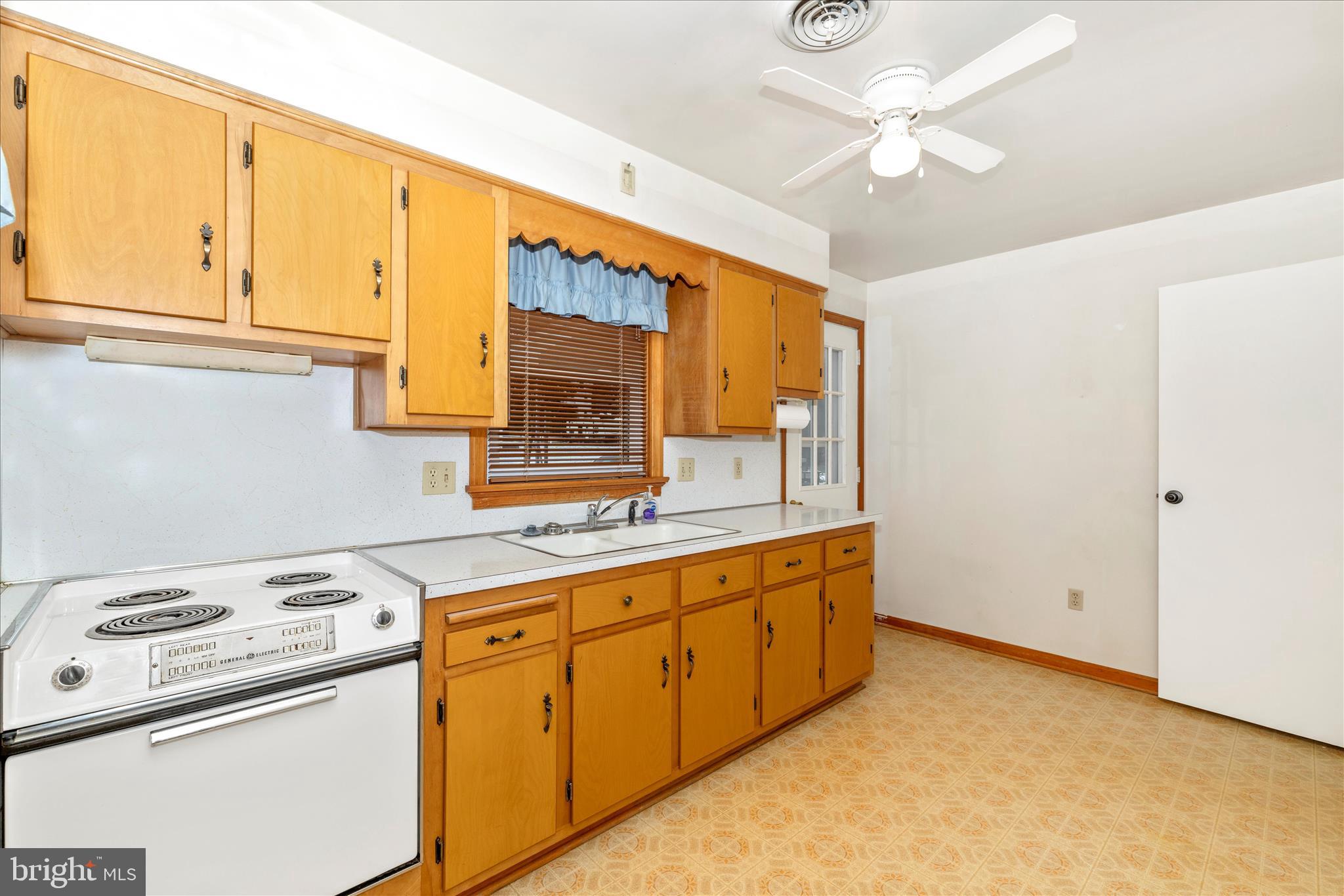 215 Broad Street Middletown, MD 21769 - Photo 32 of 56 a kitchen with cabinets a sink and appliances