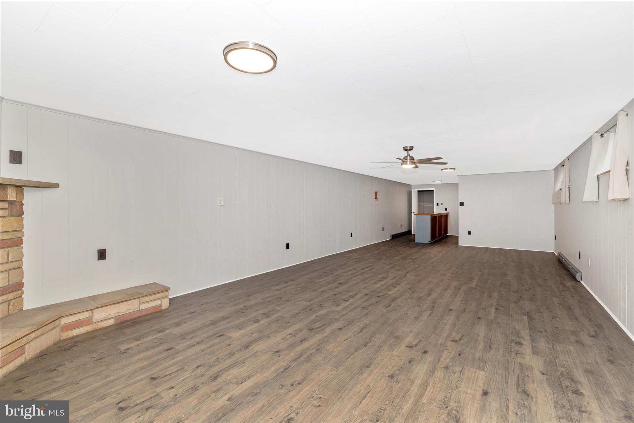 215 Broad Street Middletown, MD 21769 - Photo 37 of 56 a view of a room with wooden floor and ceiling fan