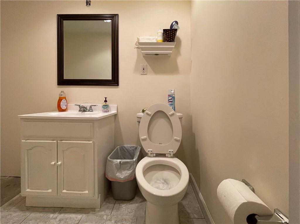 655 76th Street Brooklyn, NY 11209 - Photo 15 of 30 a bathroom with a toilet sink and mirror