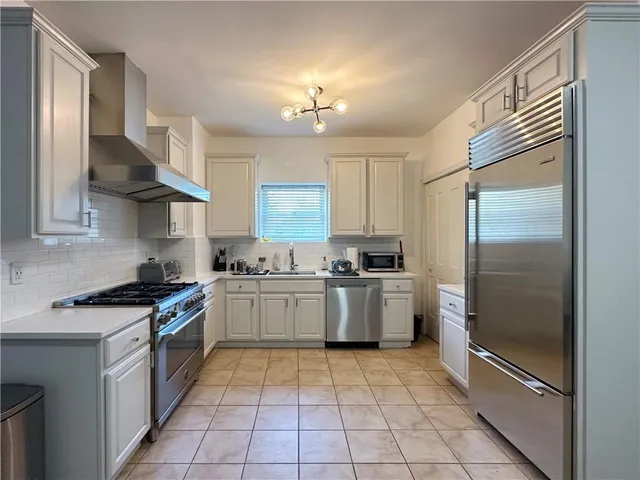 a kitchen with a table chairs refrigerator and microwave