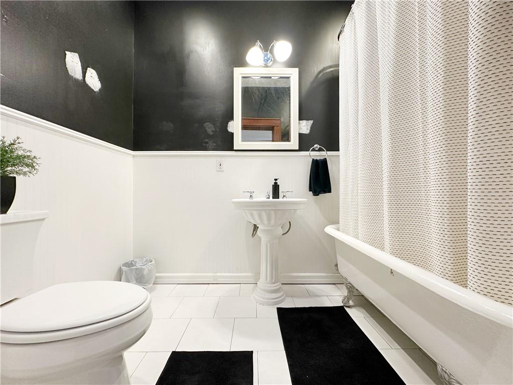 655 76th Street Brooklyn, NY 11209 - Photo 27 of 30 a bathroom with a sink and a mirror