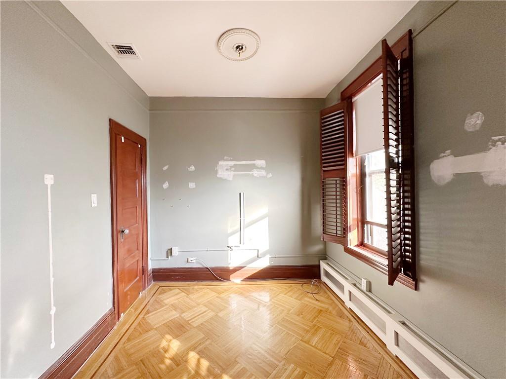 655 76th Street Brooklyn, NY 11209 - Photo 29 of 30 a view of an empty room with a fireplace and a window