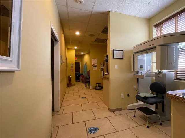 a view of a hallway with workspace and a window