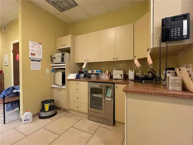 a kitchen with stainless steel appliances granite countertop a sink a stove and a refrigerator