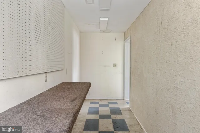 a view of a closet area with wooden floor
