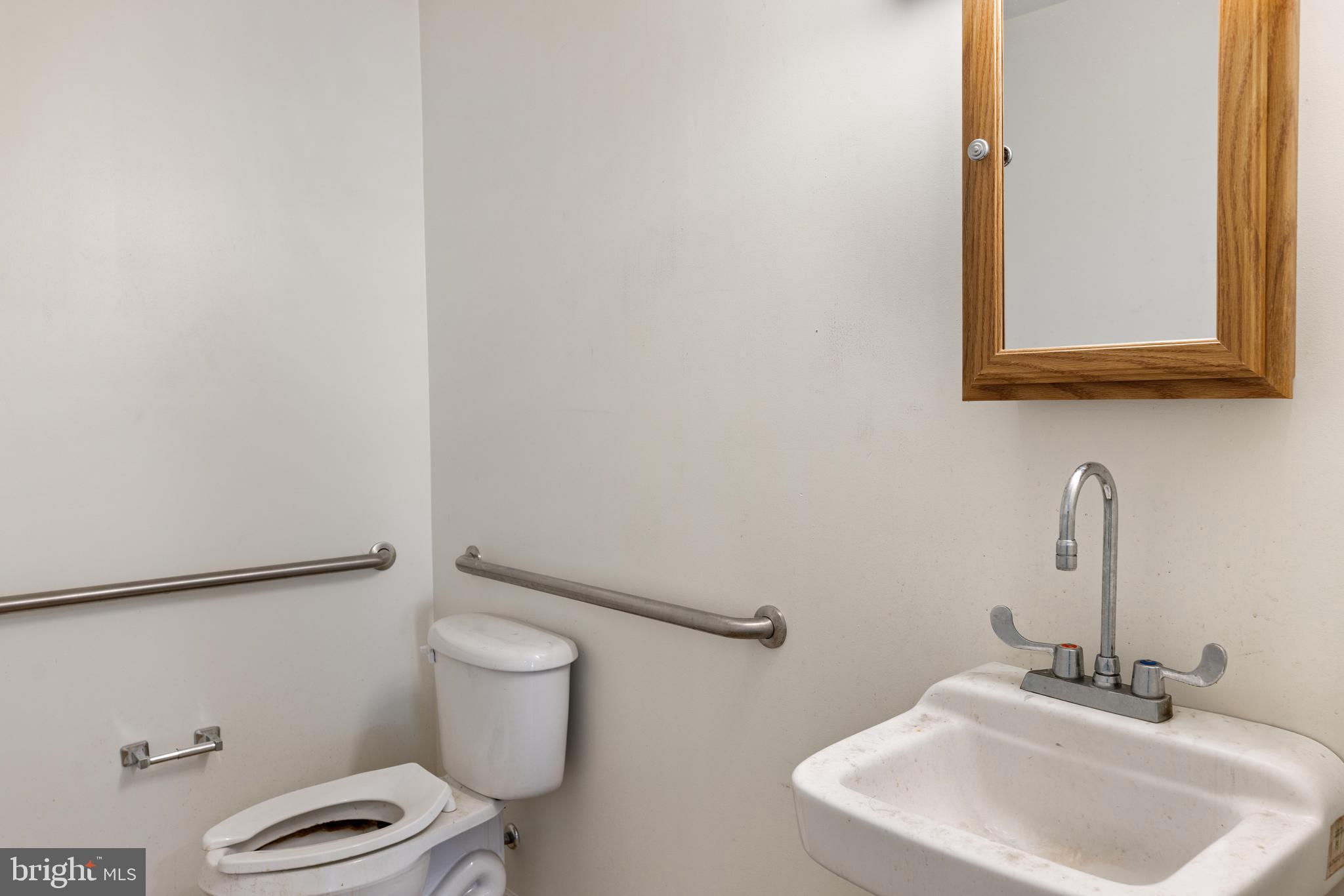 7026 Ridge Avenue Philadelphia, PA 19128 - Photo 12 of 24 a bathroom with a toilet sink and mirror
