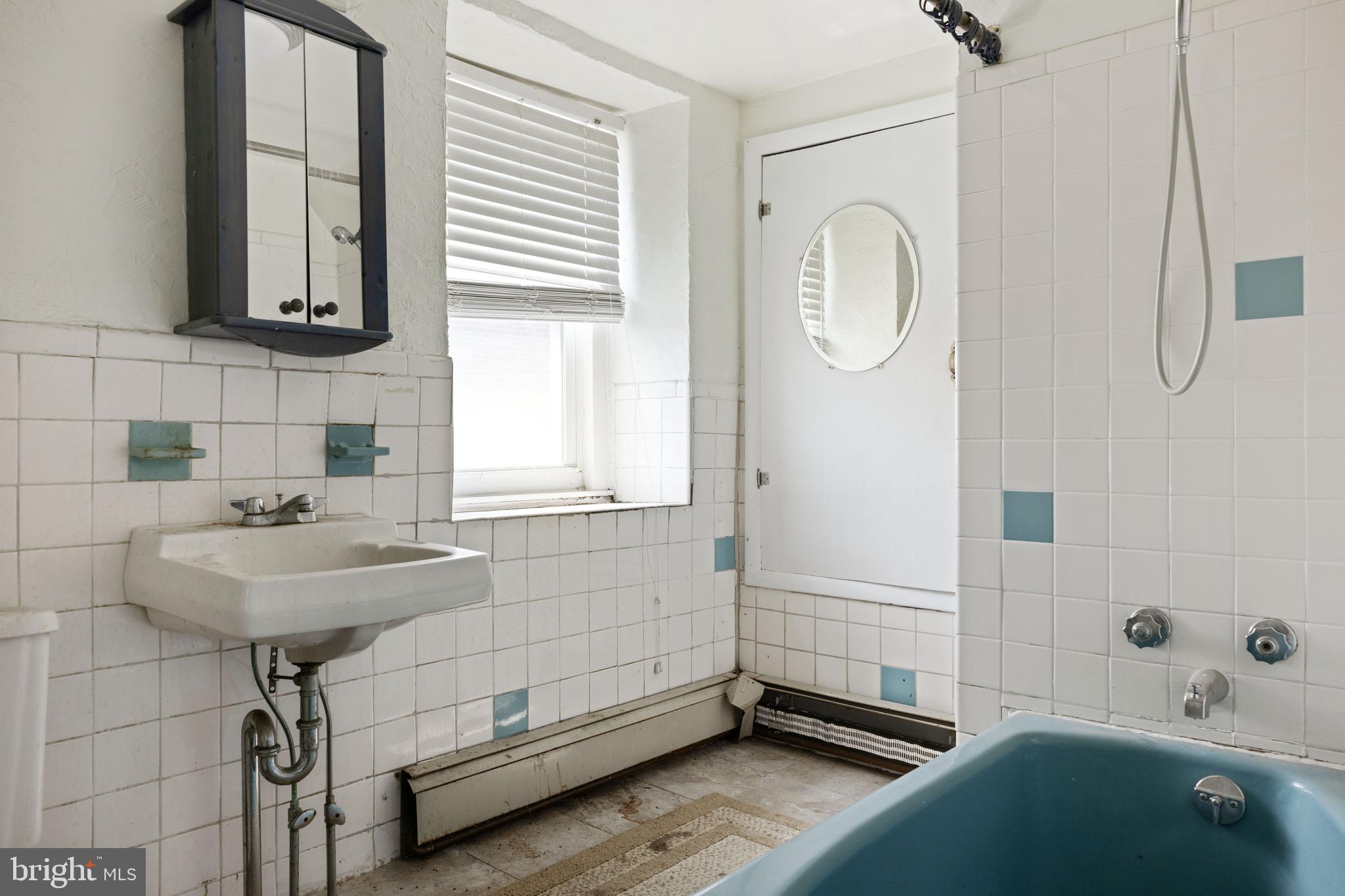7026 Ridge Avenue Philadelphia, PA 19128 - Photo 18 of 24 a bathroom with a sink a toilet and a mirror