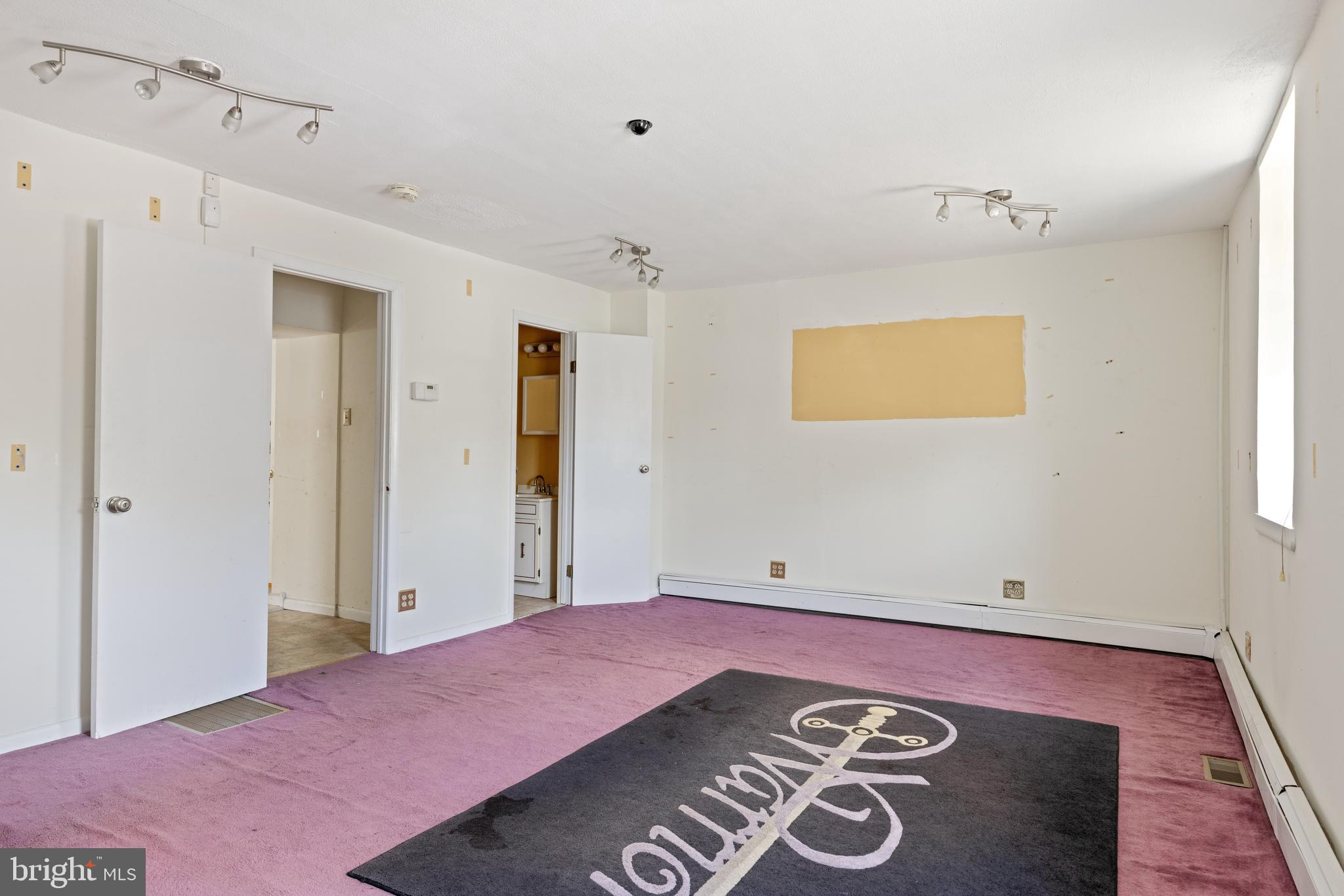 7026 Ridge Avenue Philadelphia, PA 19128 - Photo 4 of 24 a bedroom with a bed and a table