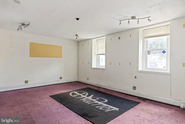a view of a room with wooden floor and window