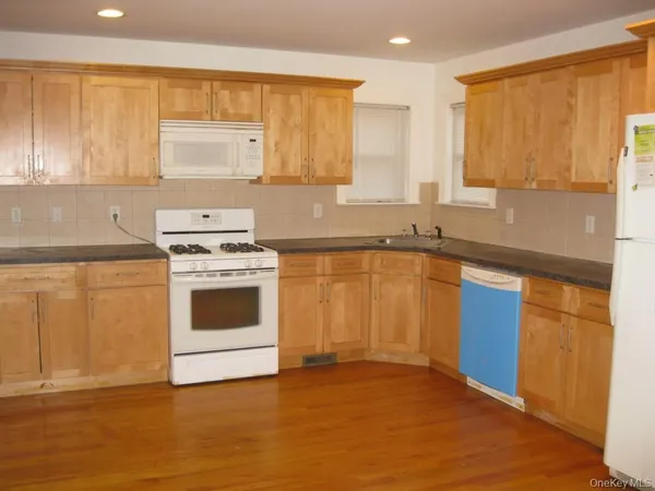 a kitchen with a stove a sink and a microwave