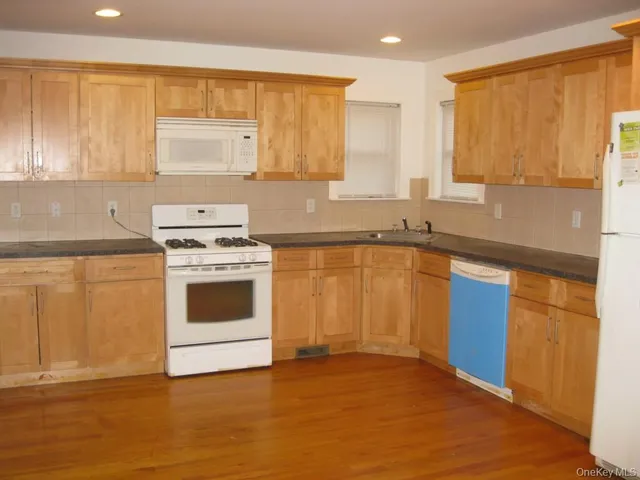a kitchen with a stove a sink and a microwave