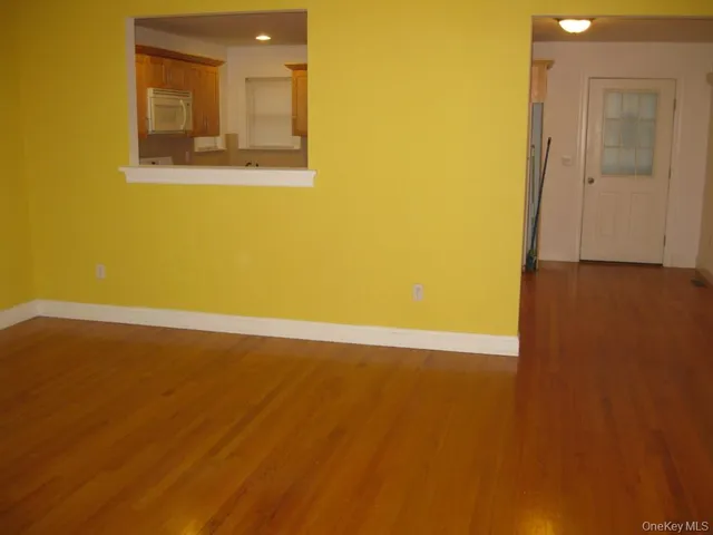 a view of an empty room and wooden floor